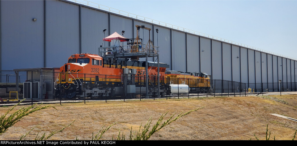 BNSF 3282 sits under the Wabtec Emissions Testing Rig with UP 5704 (C44ACM) Beside Her.